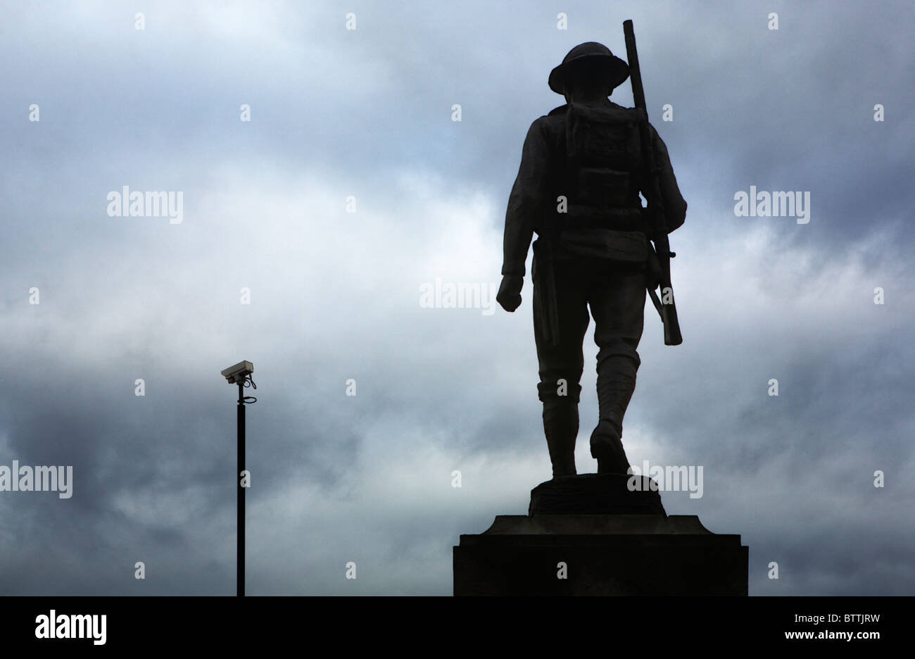 Bronze statue of a World War 2 soldier overlooking a modern CCTV camera, London, UK Stock Photo