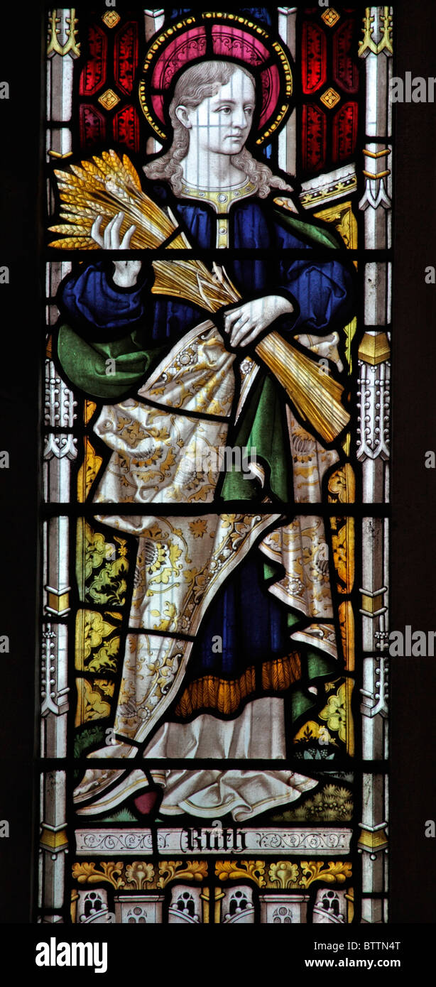 A stained glass window depicting Ruth The Matriarch holding a sheaf of wheat Stock Photo