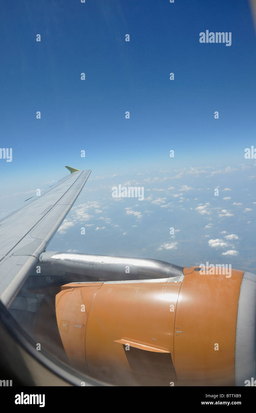View from airplane window with view of wing and jet engine Stock Photo