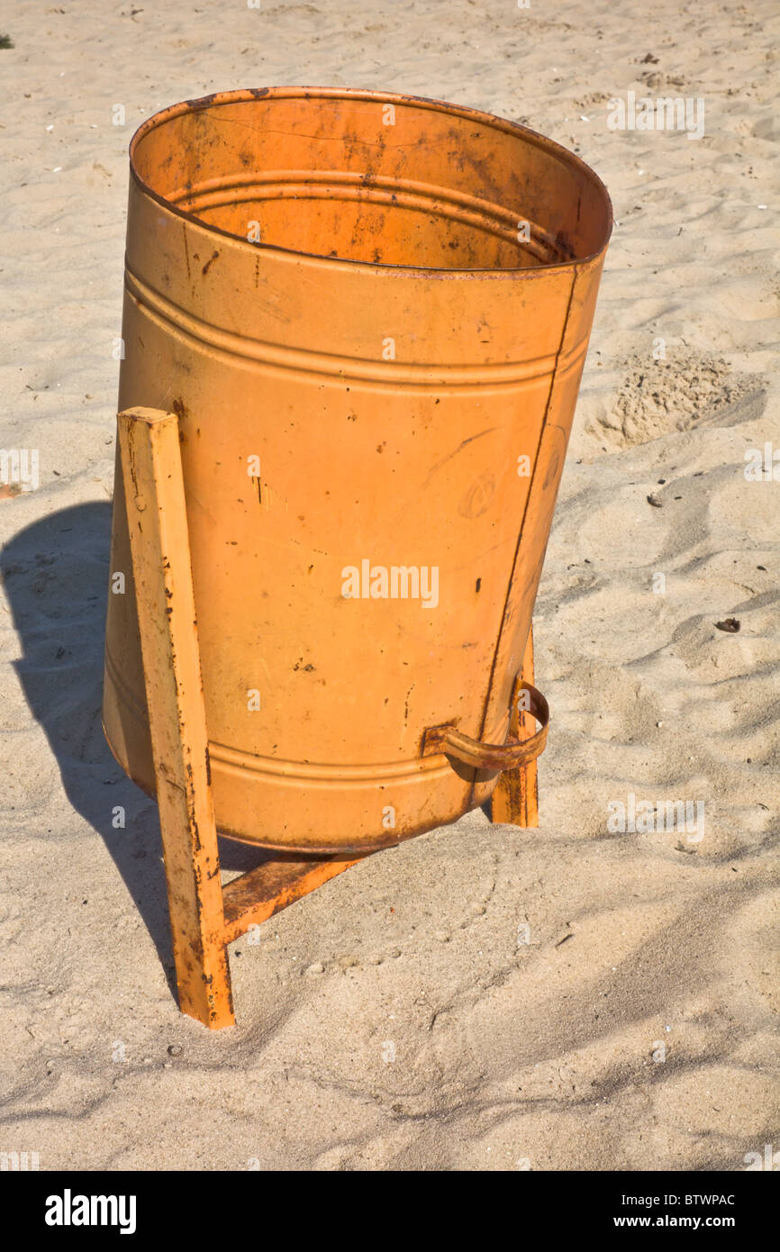 Orange garbage can on the sand beach Stock Photo Alamy