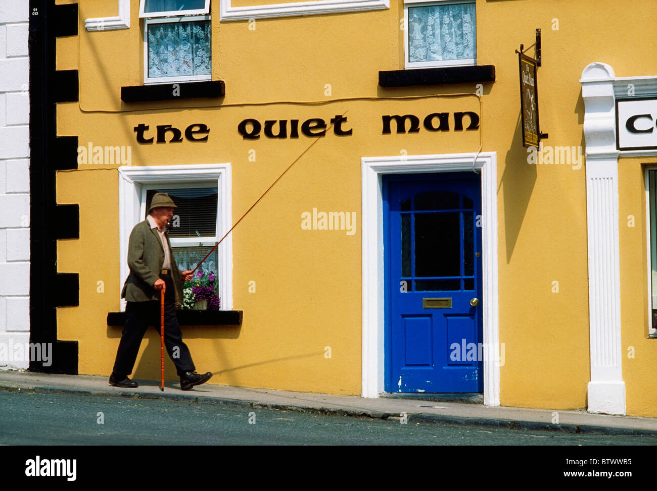Cong, Co Mayo, Ireland; Man Walking Past A Traditional Pub Stock Photo