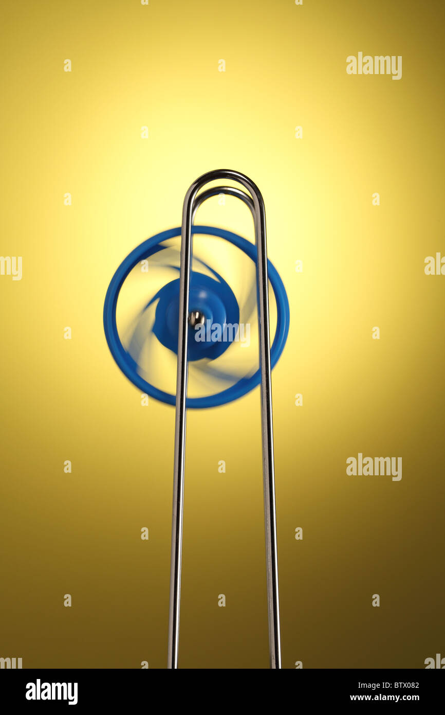 Blue wheel spinning on a silver metal rail. The wheel climbs up and ...