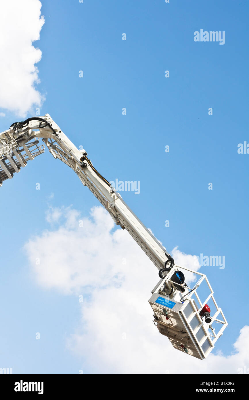 Articulated aerial hydraulic platform against a blue sky Stock Photo