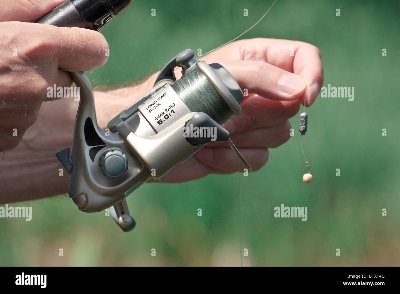 Closeup of a fisherman hand holding a fishing rod Stock Photo - Alamy