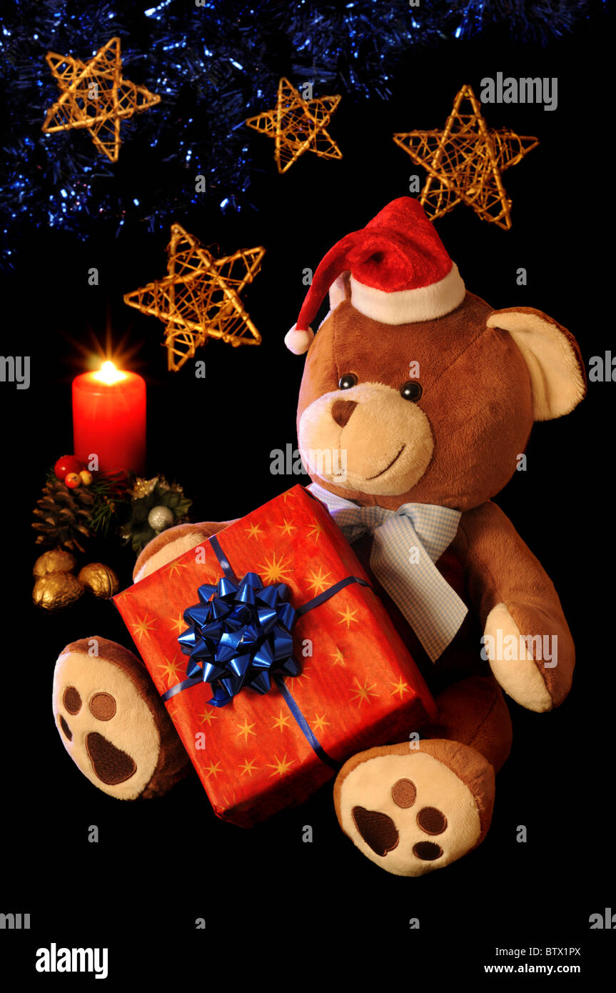 Christmas teddy bear with gift and holiday decoration. Stock Photo