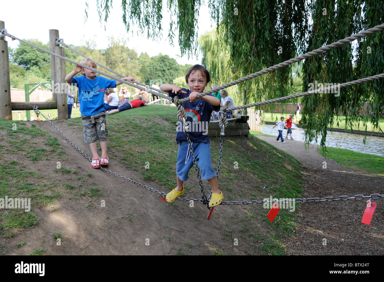 Young boy playing in the adventure playground at Newby hall, north yorkshire, uk Stock Photo