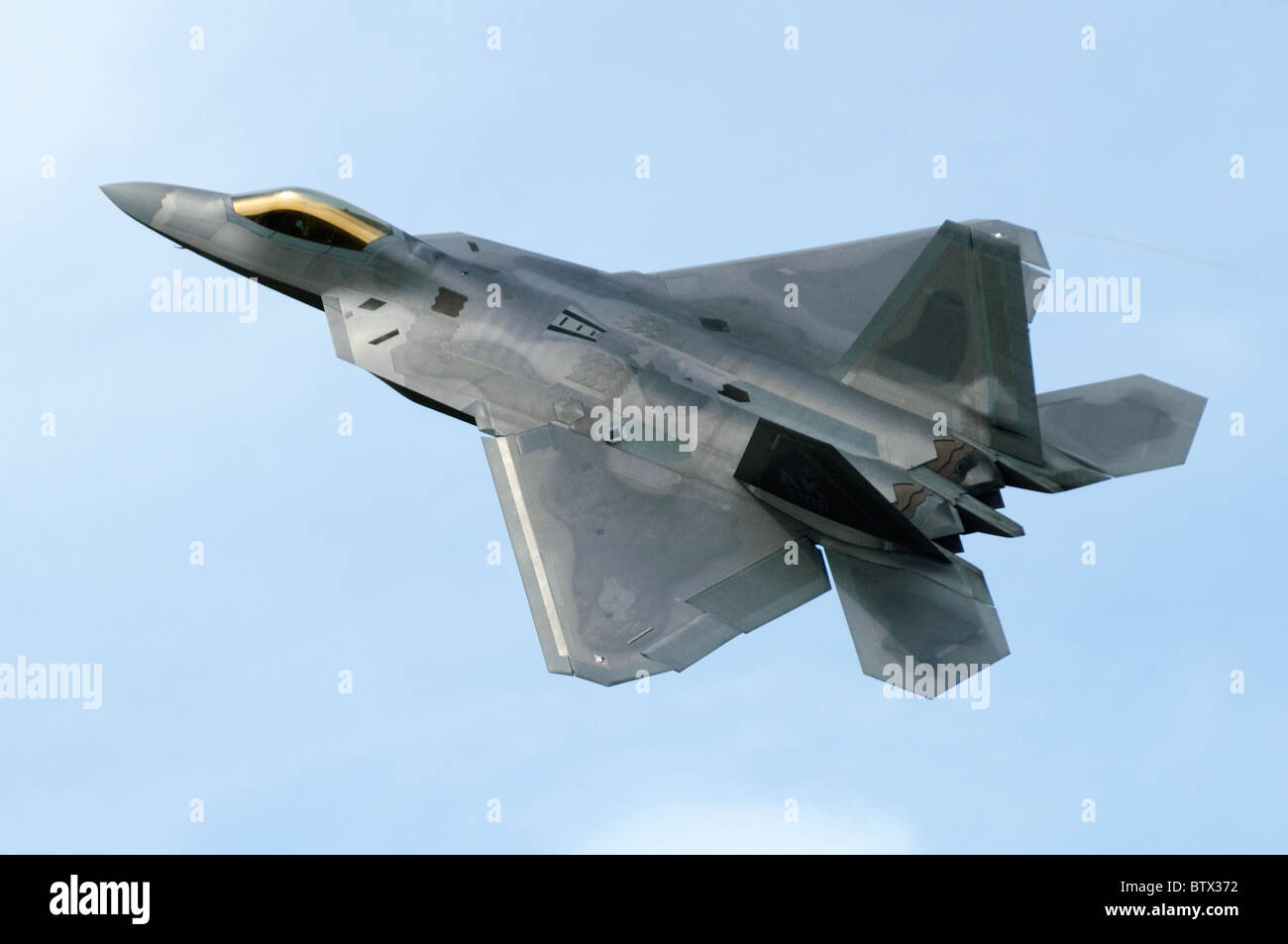 F-22 Raptor aircraft operated by the US Air Force departing RAF Fairford, UK. Aircraft is a Lockheed Martin F-22A Raptor. Stock Photo