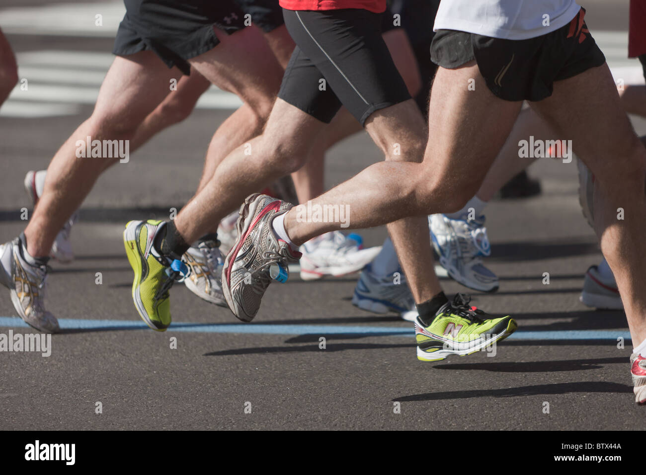 The legs and feet of runners during the 2010 New York City Marathon. Stock Photo