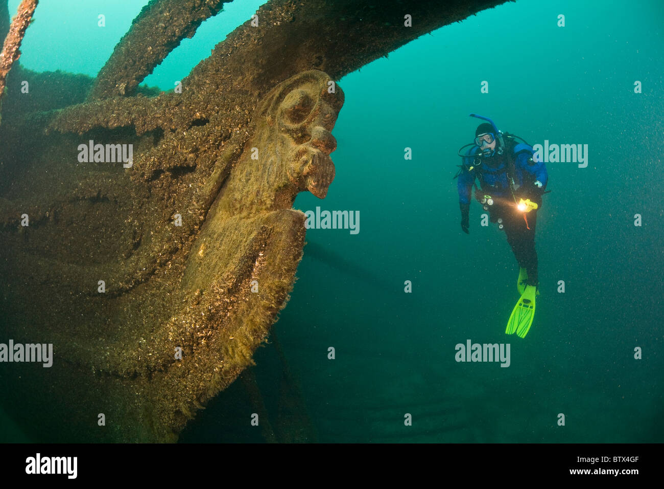 A diver explores the bow of a sunken ship in Lake Michigan. Stock Photo