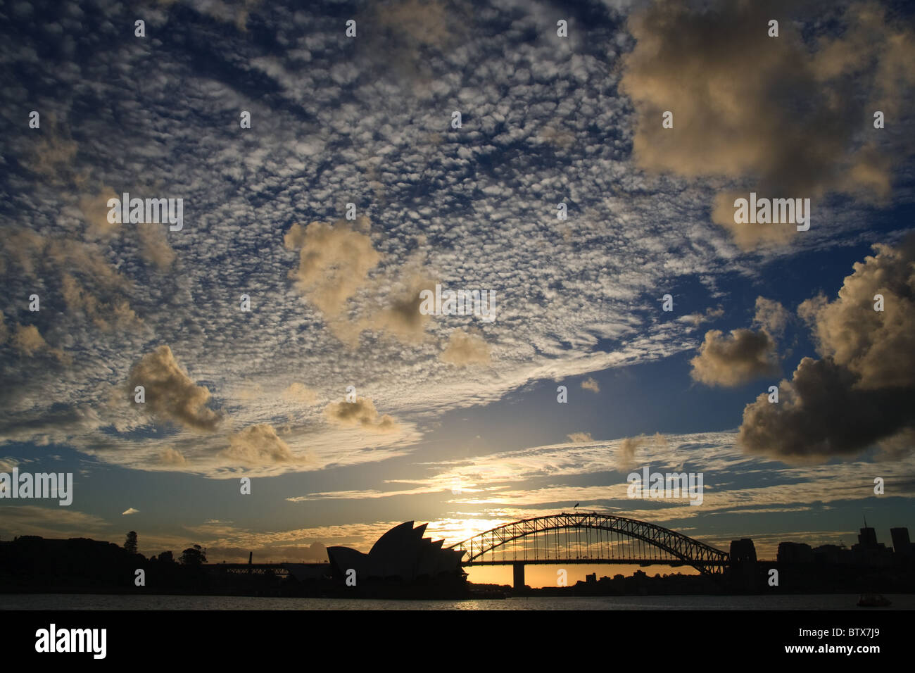 Dramatic Sky over Sydney Opera House and Sydney Harbour Bridge Silhouette Sunset Stock Photo