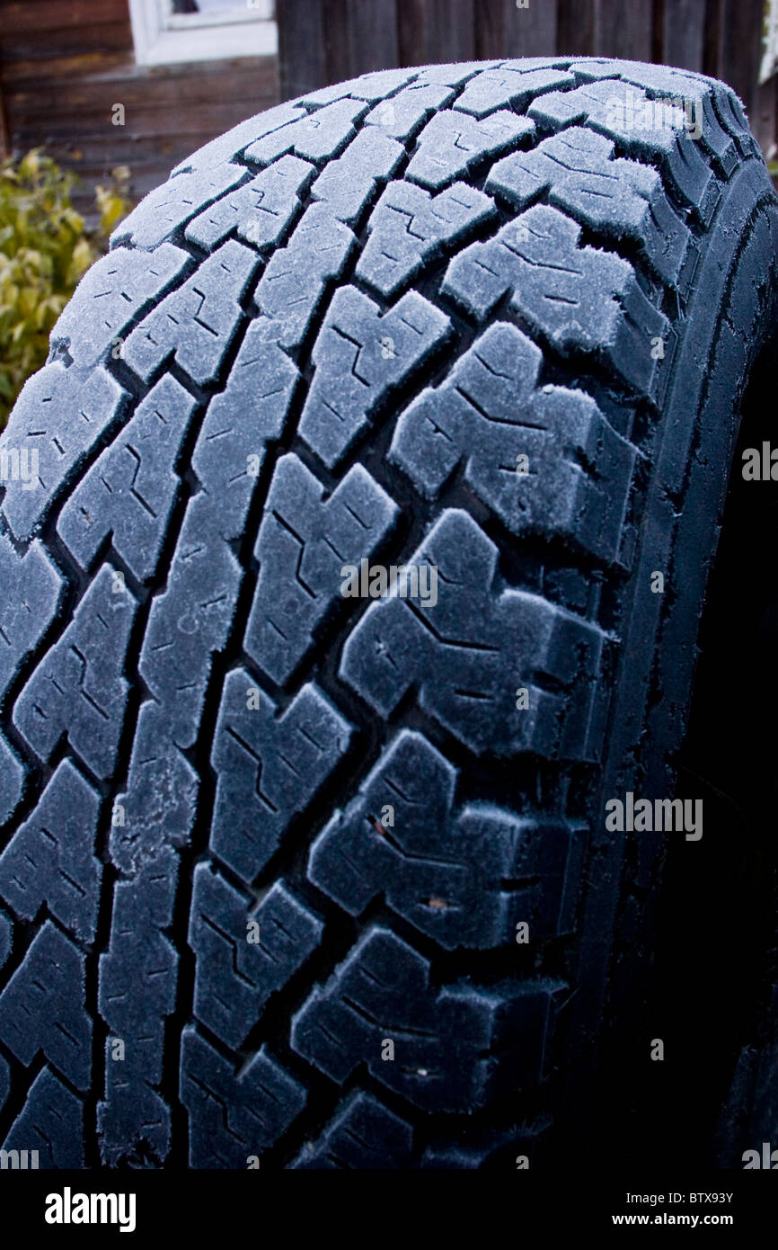 Jeep tire tread frosted in winter background Stock Photo