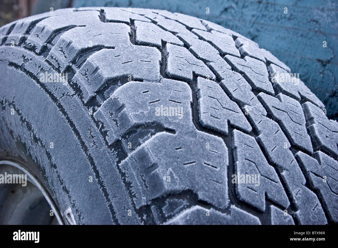 Jeep tire tread frosted in winter background Stock Photo
