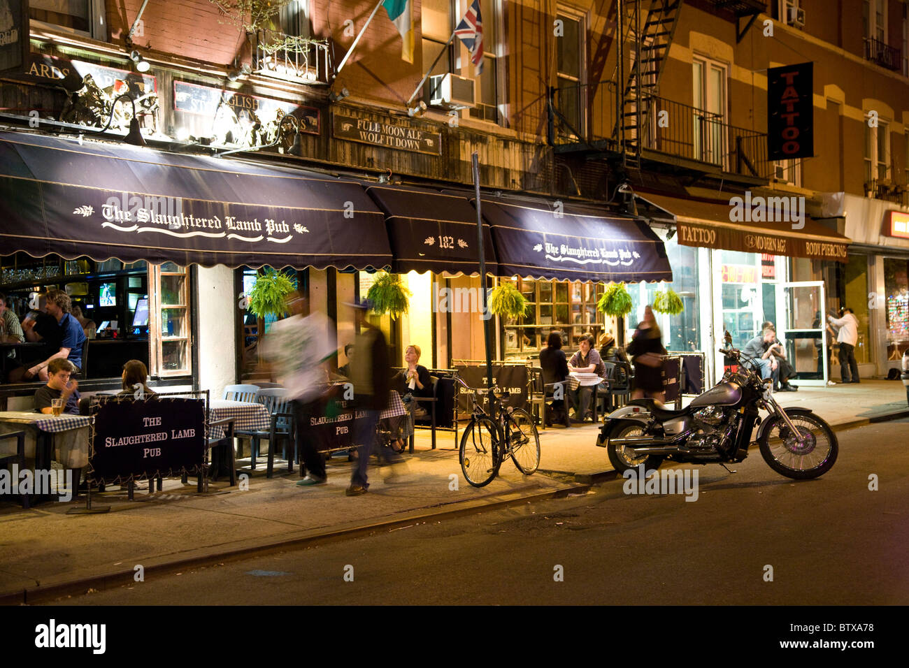 Motorbike parked outside The Slaughtered Lamb Pub in Greenwich Village, New York Stock Photo