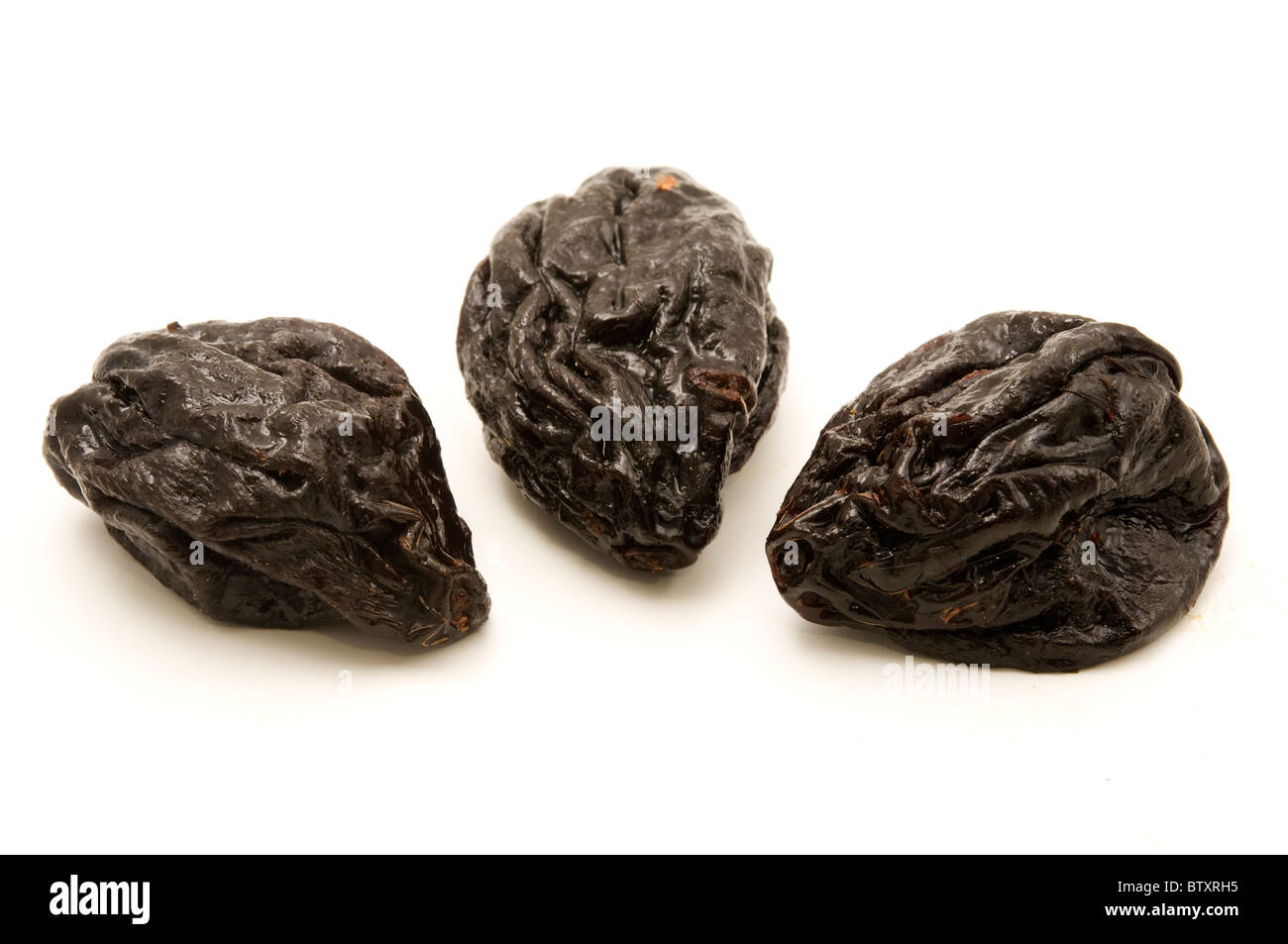 Dried plums on a white background Stock Photo