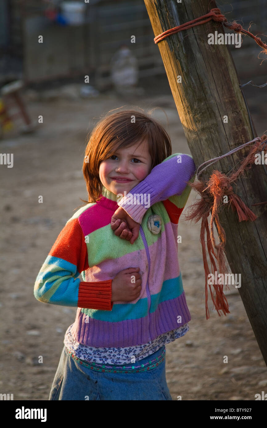 Farmer daughter poses in the farmyard Stock Photo