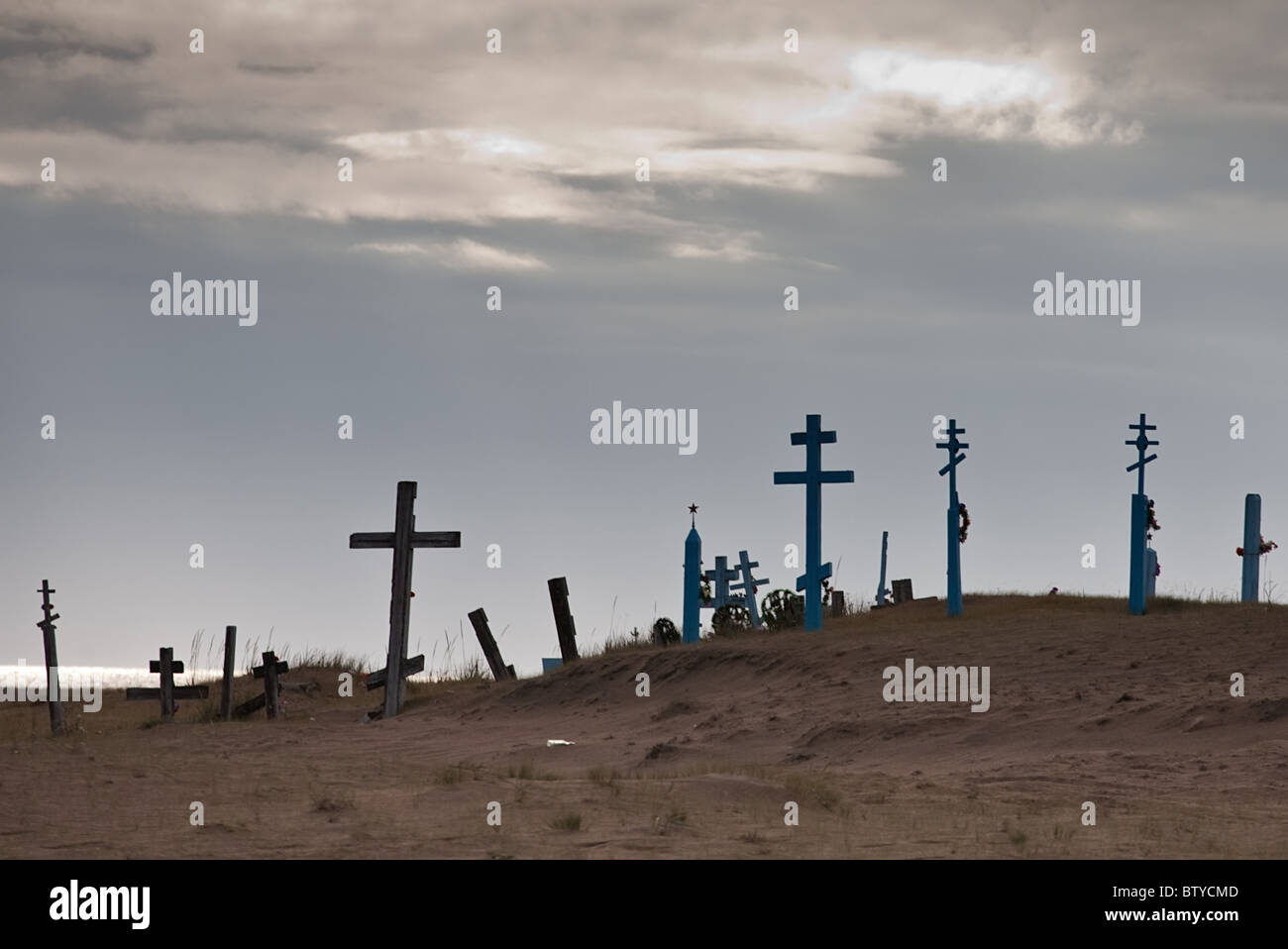 old Russian abandoned rural cemetery with wooden crosses and red Soviet ...