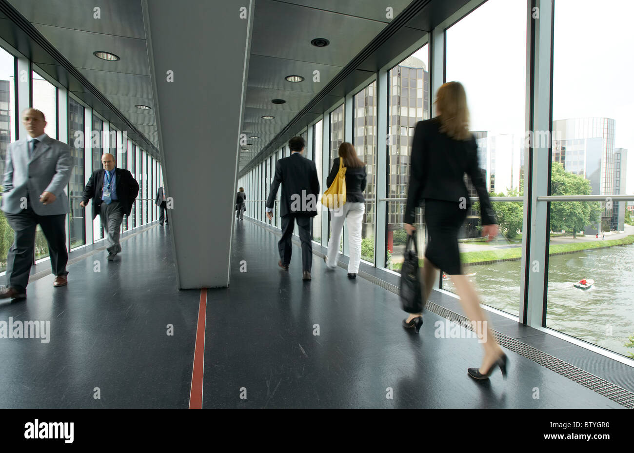 Parliamentarians walking through a glass skywalk, Strasbourg, France Stock Photo