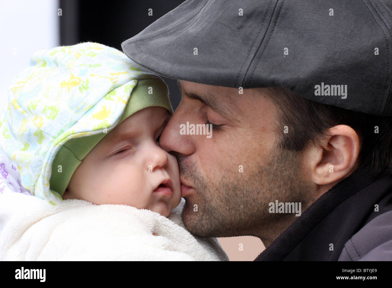 Father kissing his baby son stock image