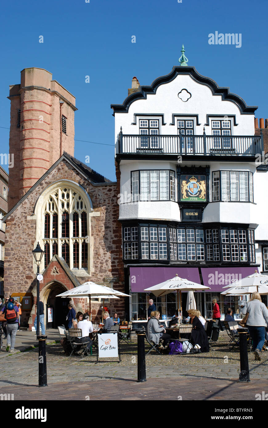 Historic buildings and pavement cafe at Exeter Cathedral yard. Stock Photo