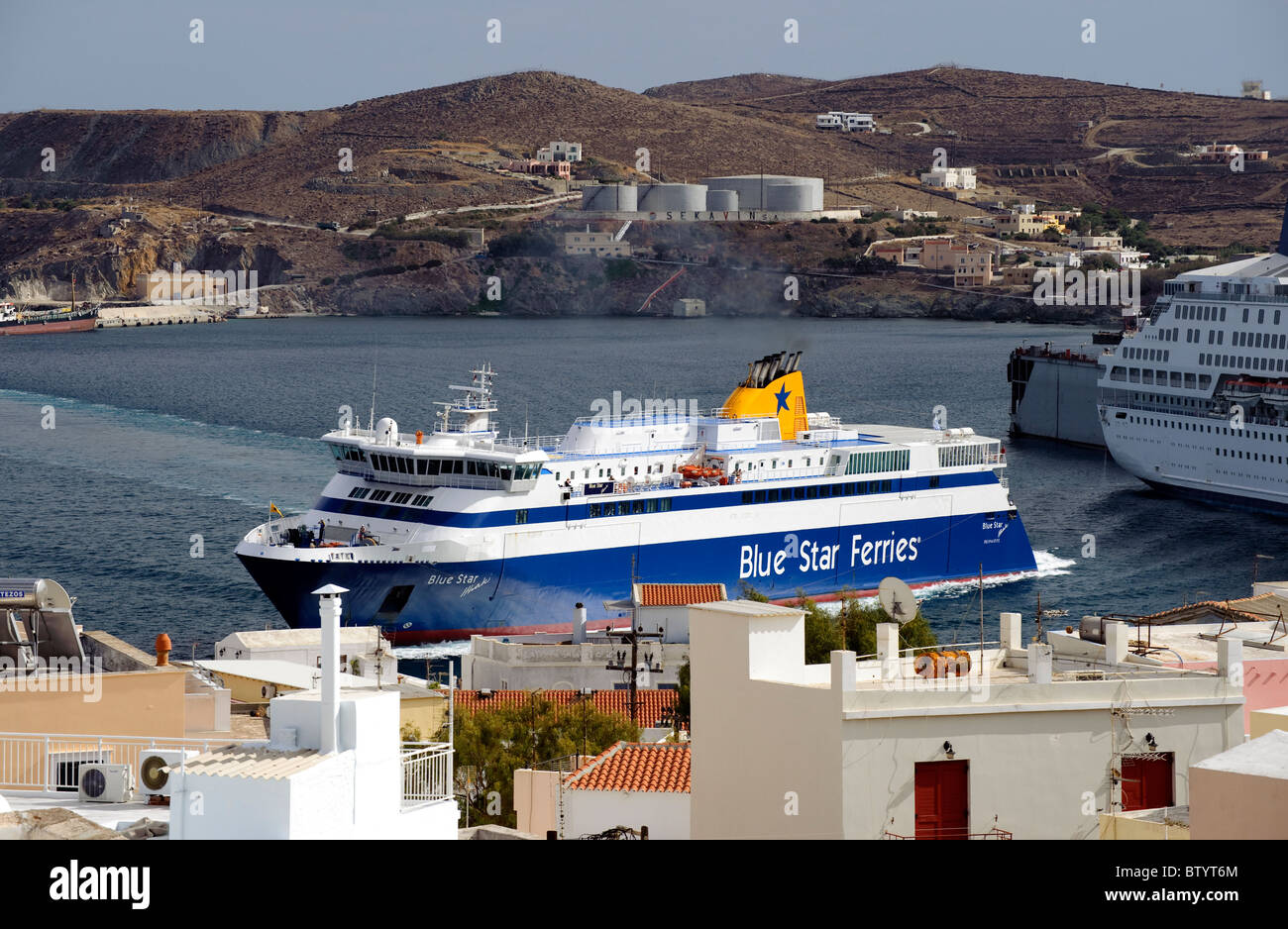 View of a Blue Star ferry berthing in the port of Ermoupolis, on the Greek Cyclade island of Syros. Stock Photo
