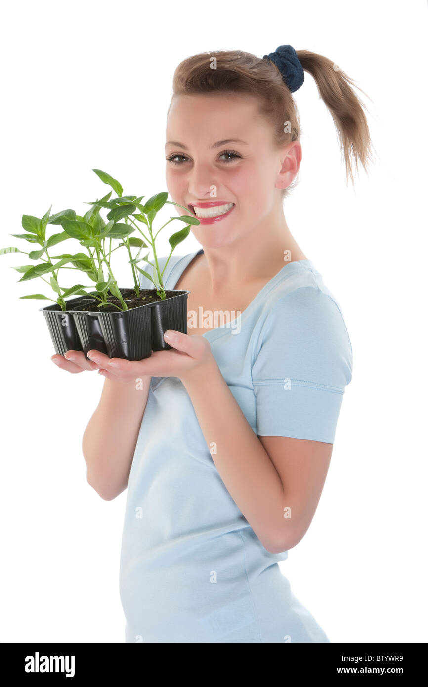 Portrait of a beautiful happy young woman holding plant Stock Photo - Alamy
