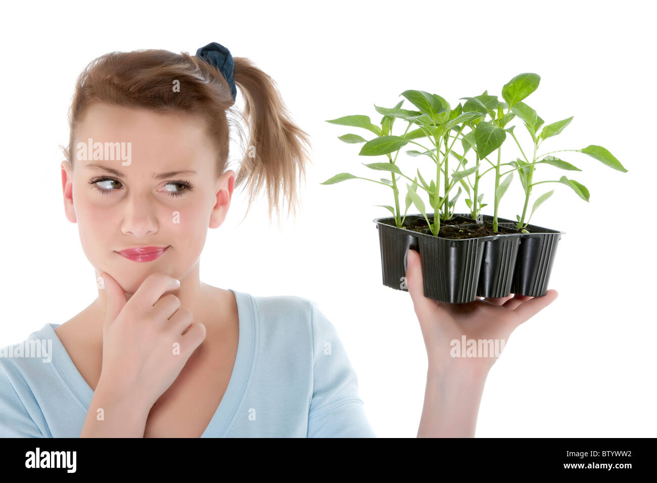 Portrait of a beautiful happy young woman holding plant Stock Photo - Alamy
