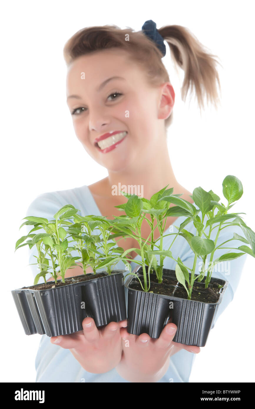Portrait of a beautiful happy young woman holding plant Stock Photo - Alamy
