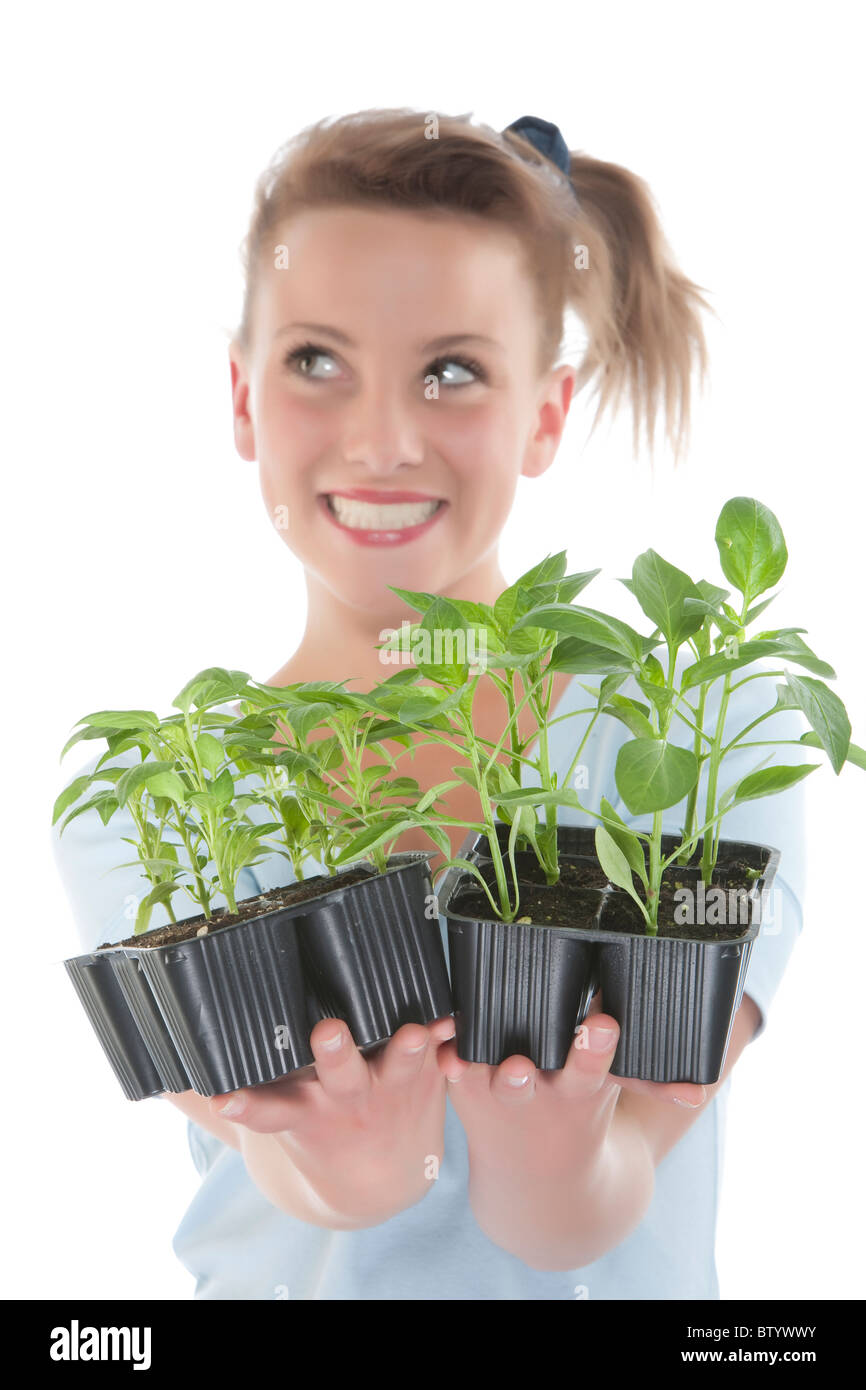 Portrait of a beautiful happy young woman holding plant Stock Photo - Alamy