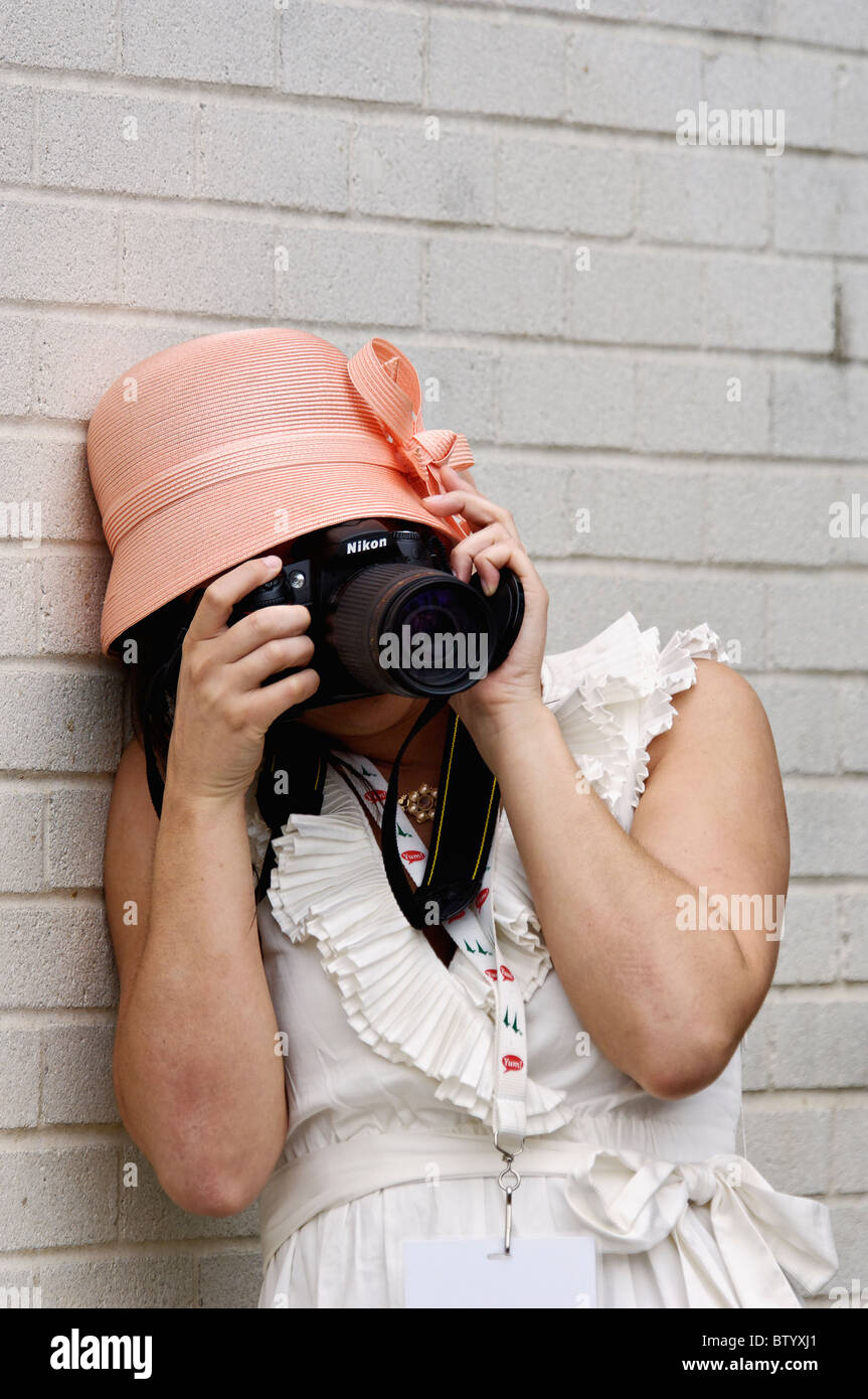 Photo of Woman Taking a Photo with a Nikon SLR Digital Camera at the 2010 Kentucky Derby in Louisville, Kentucky Stock Photo