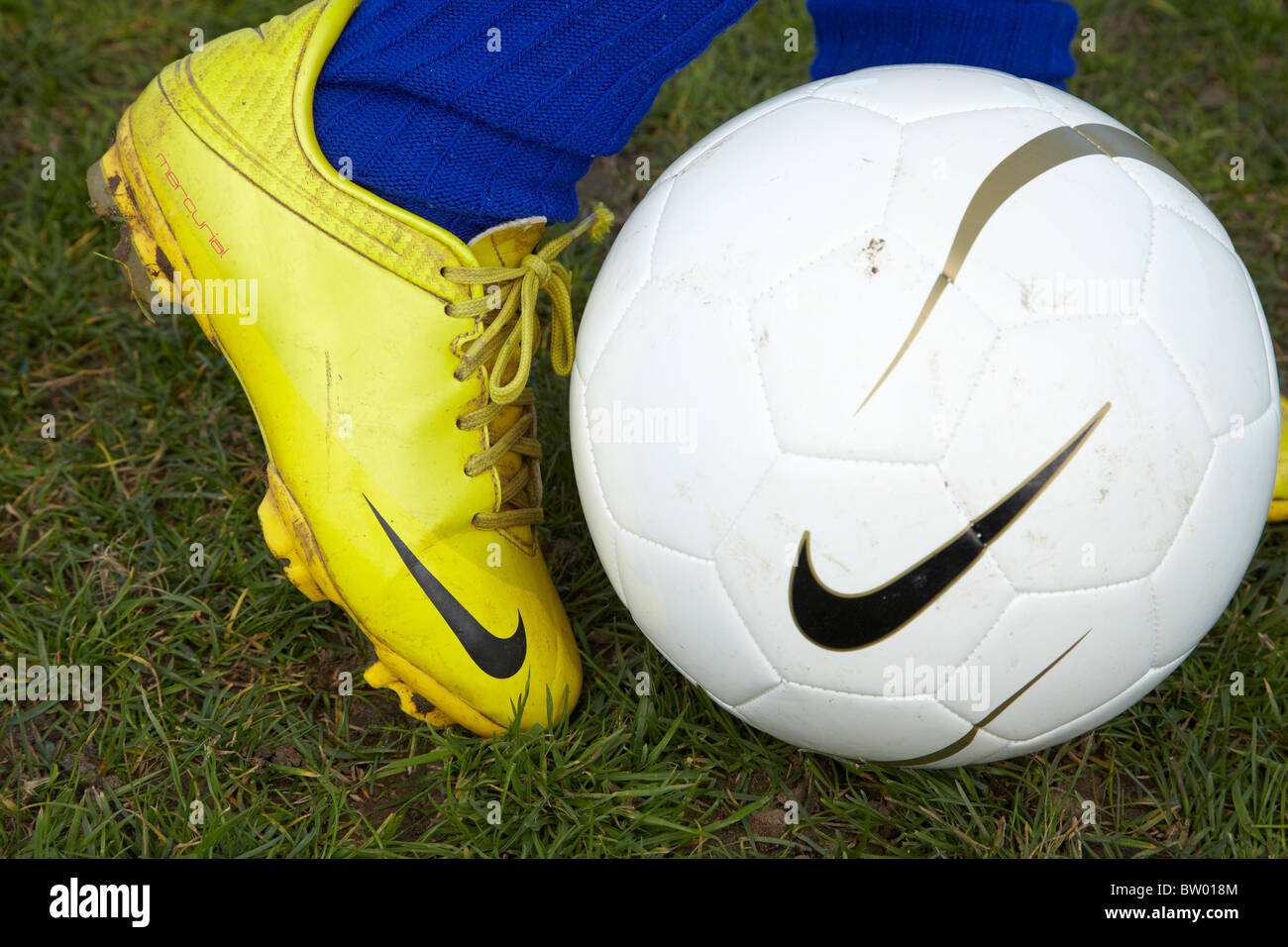 Young boy kicking football Stock Photo