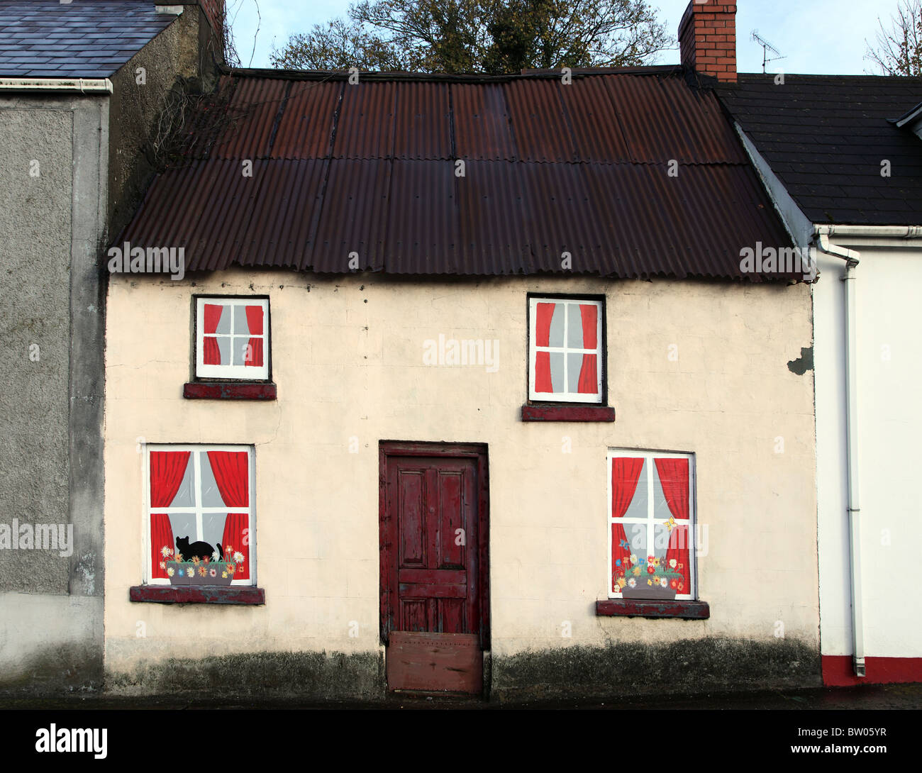 Derelict cottage with trompe l'oeil paintings, Carrickmacross, Ireland Stock Photo