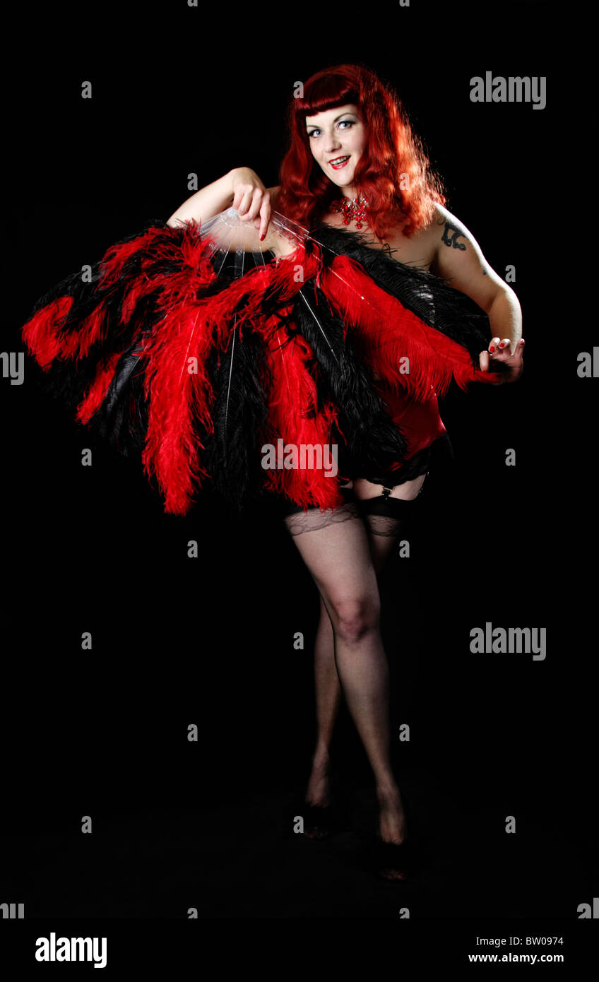 Burlesque Performer Dancing with Red and Black Fans Stock Photo - Alamy