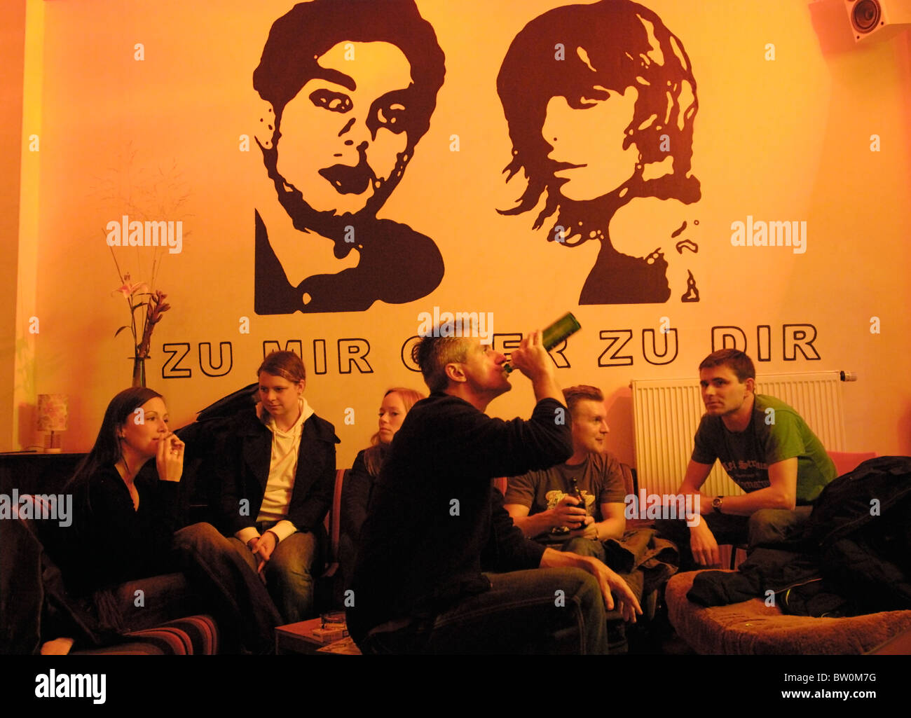 Bar scene with a caption ZU MIR ODER ZU DIR, Berlin, Germany Stock Photo