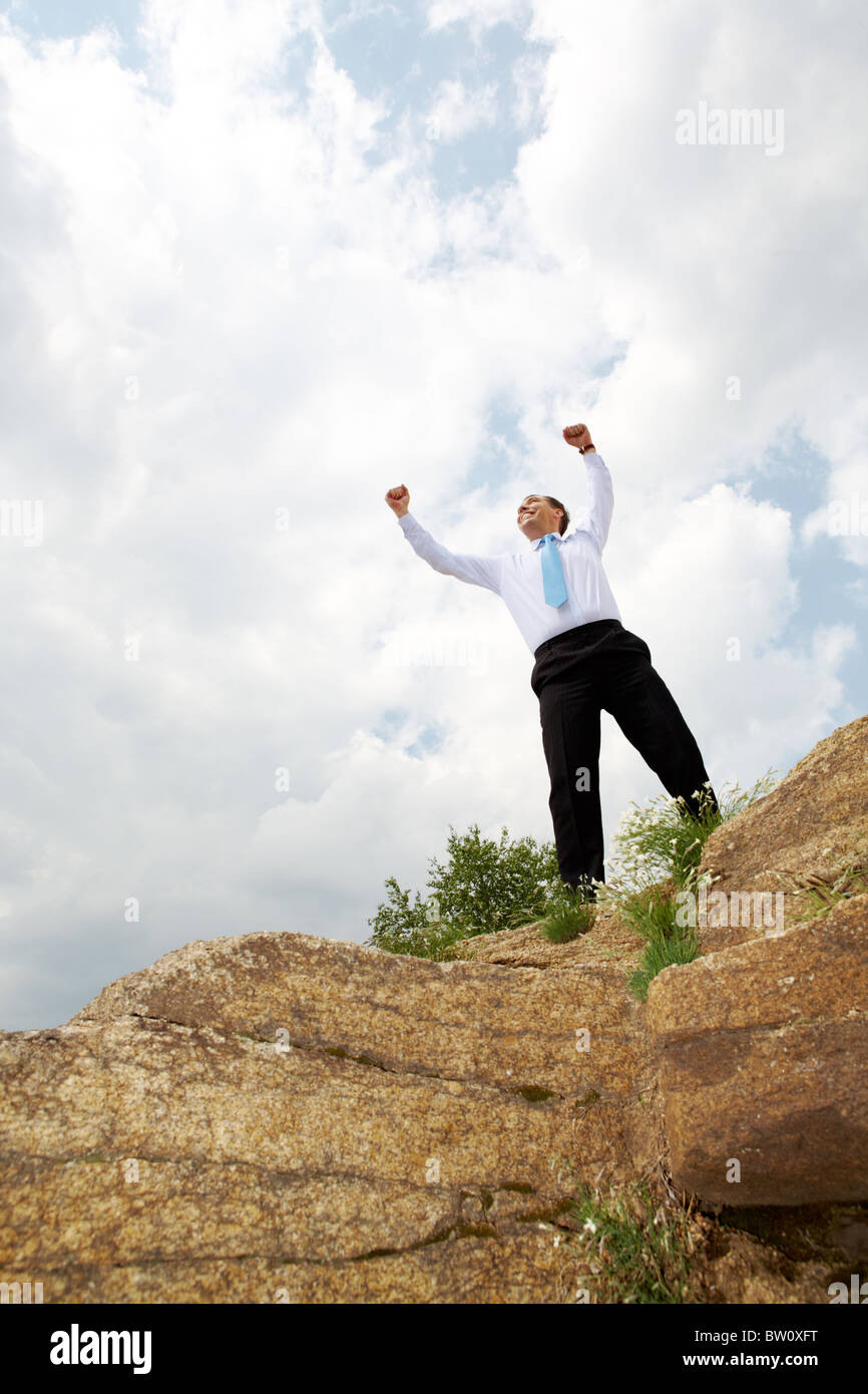 Photo of relaxed businessman standing and raising his arms outdoors in ...