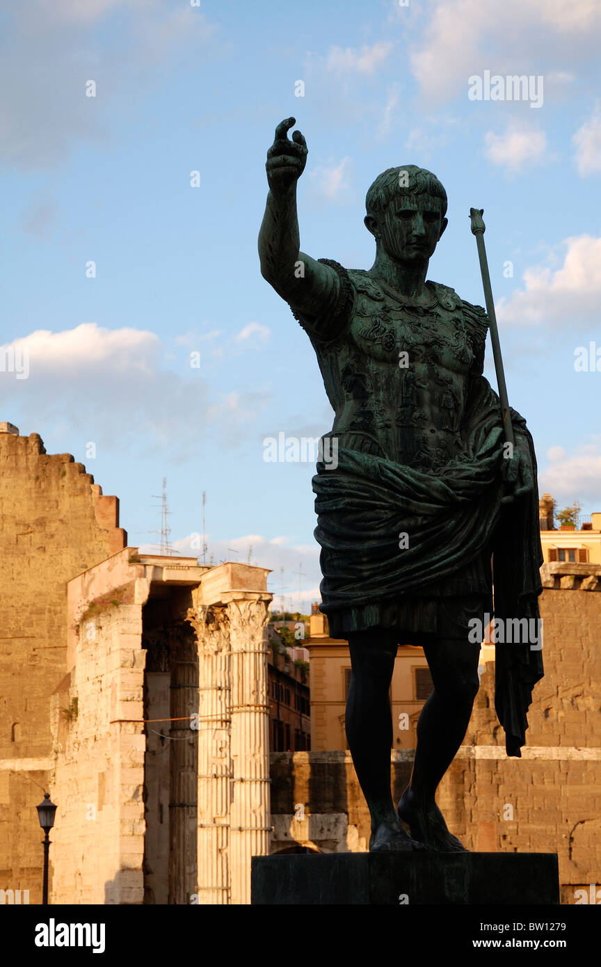 Statue of Augustus silhouetted against Trajan Forum, Fori Imperiali Stock Photo