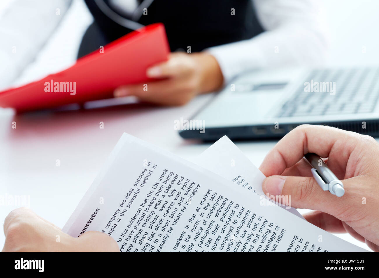 Close-up of businessman hand holding papers and pen Stock Photo - Alamy