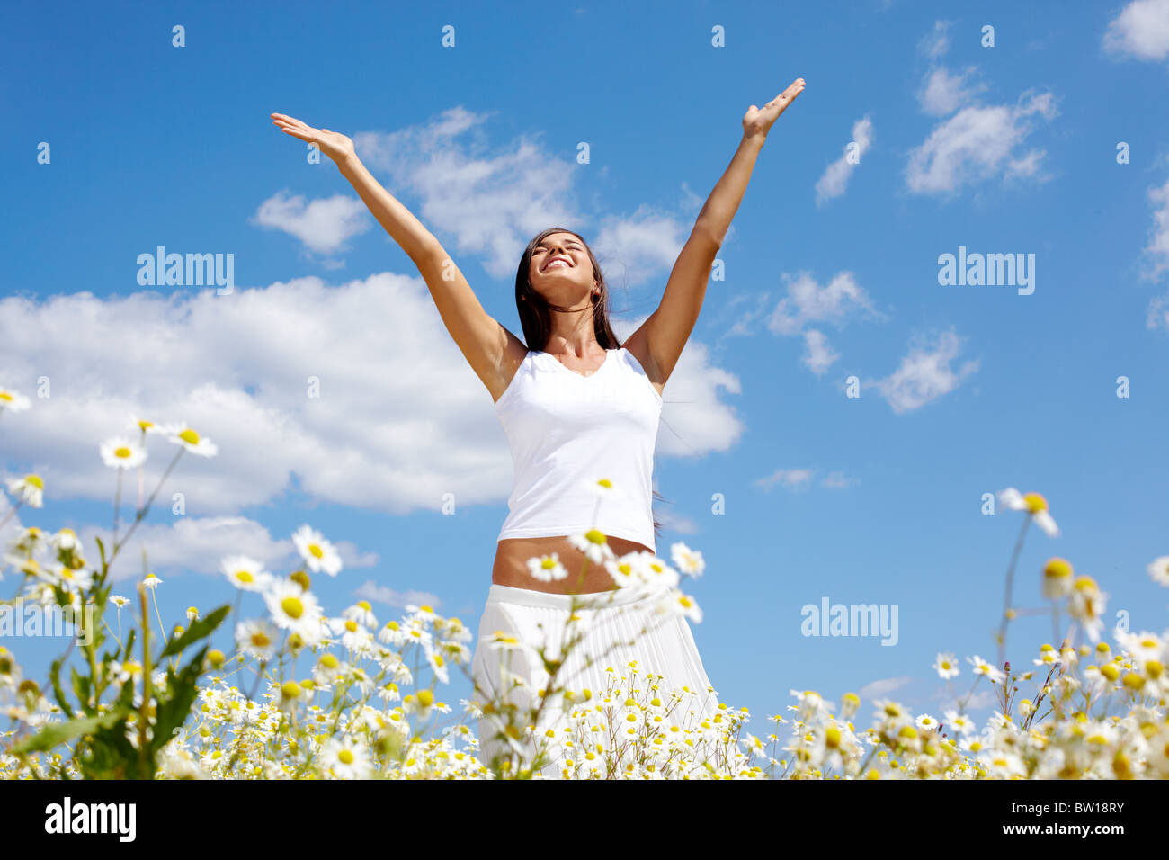 Image of happy female standing with raised arms on summer day Stock ...