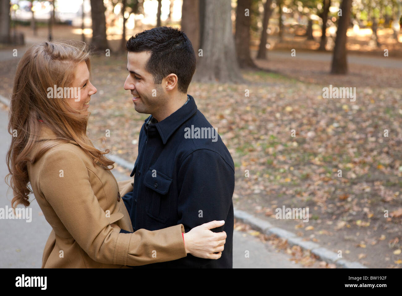 A young couple in New York's Central Park gaze lovingly into each other's eyes. Stock Photo