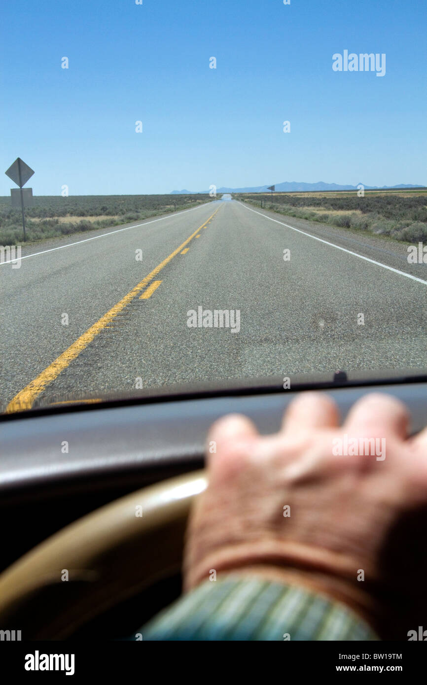 Drivers hand on the steering wheel of an automobile, Oregon, USA. Stock Photo