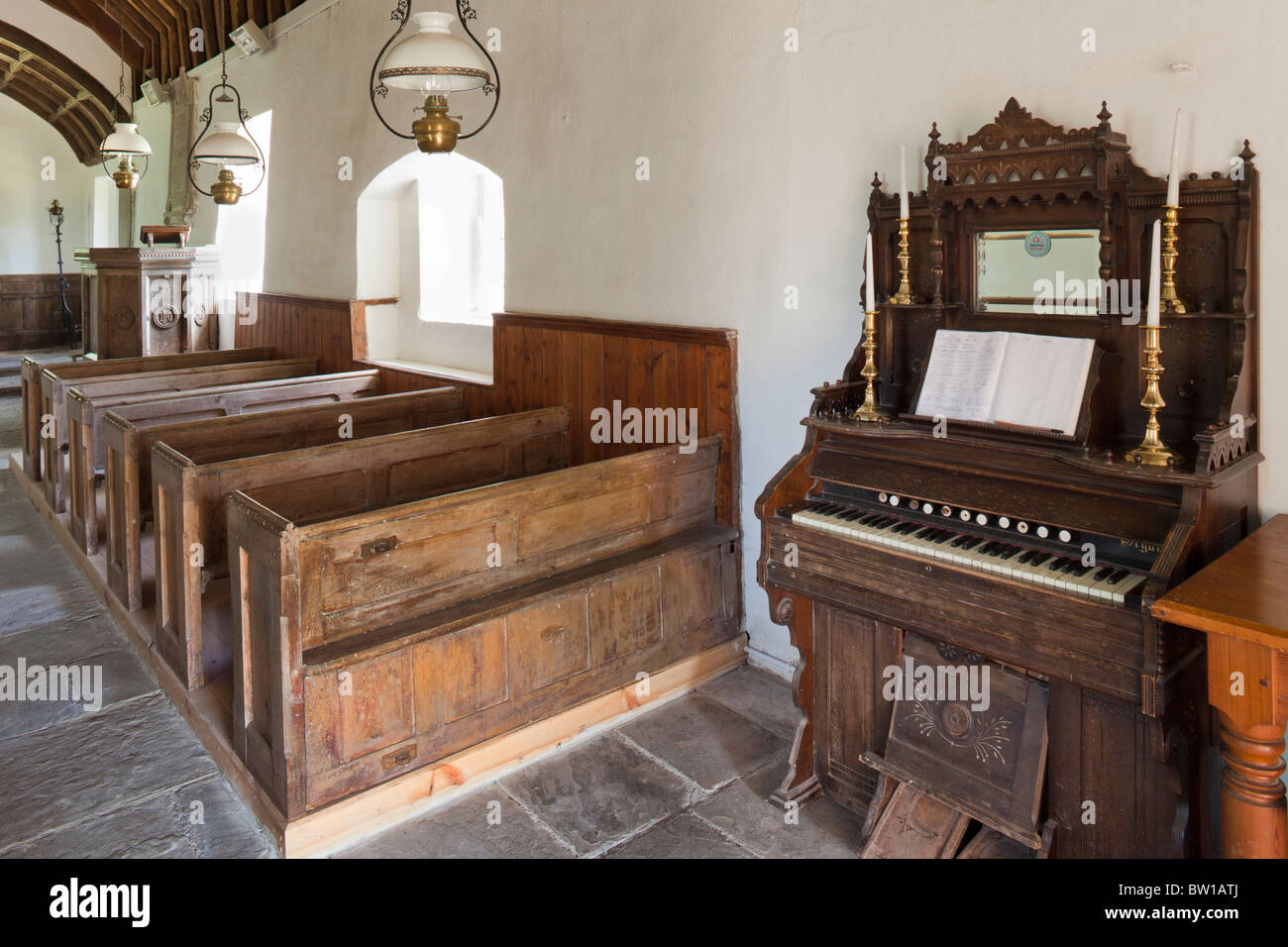 A harmonium, or American Organ, in the simple, unspoilt, interior of 14th century St Marys church, Llanywern, Powys, Wales Stock Photo