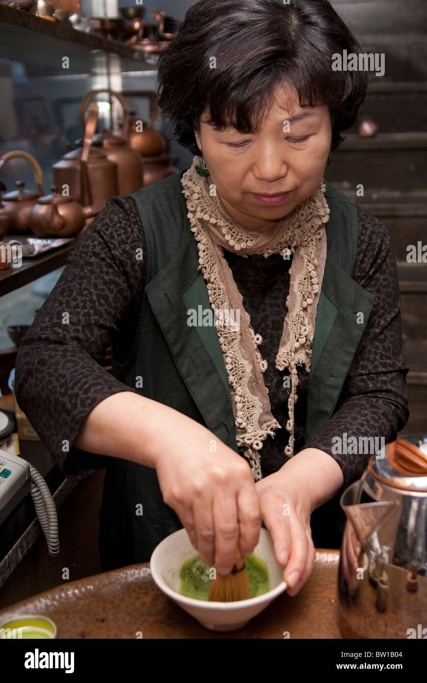 A Korean jewelry and accessory shop owner making and having tea with a guest, Seoul, South Korea Stock Photo