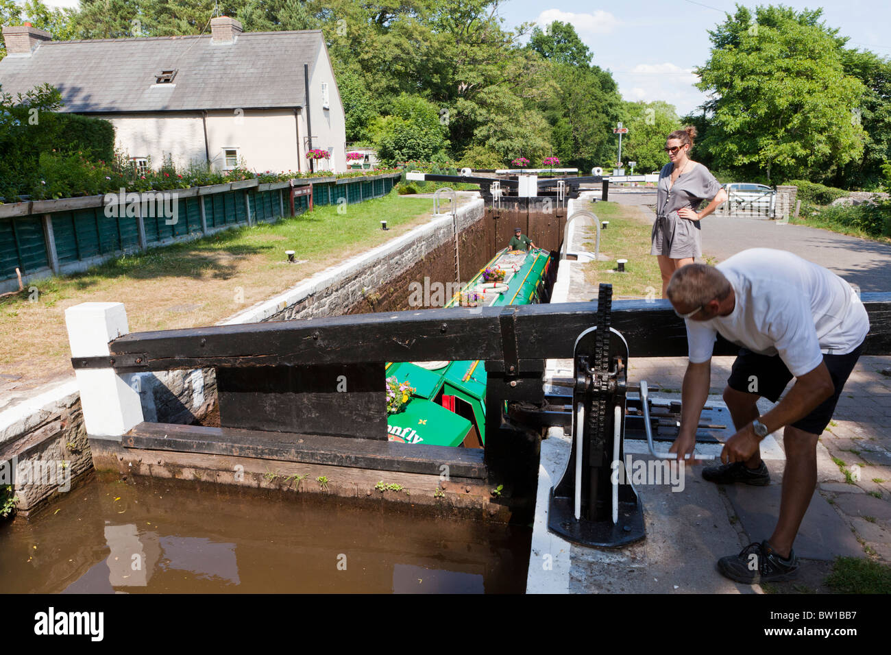 Working the lock for the Dragonfly Cruises canal trip boat on the Monmouthshire & Brecon Canal near Brecon, Powys, Wales Stock Photo