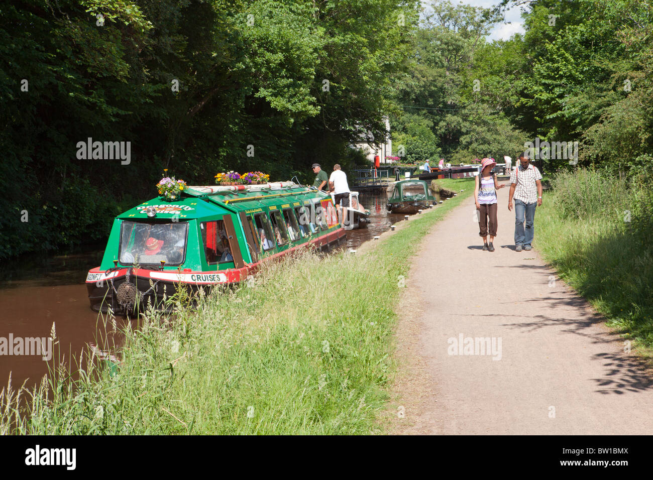 Tourists enjoying a ride on the Dragonfly Cruises canal trip boat on the Monmouthshire & Brecon Canal at Brecon, Powys, Wales UK Stock Photo