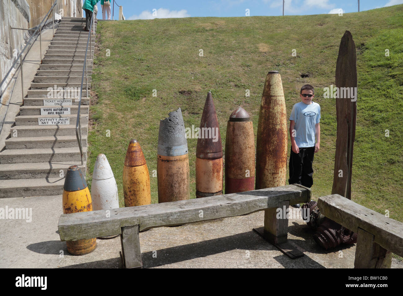 Teenage boy standing beside a range of World War Two artillery shells at the Batterie Todt Museum, Audinghen, France. Stock Photo