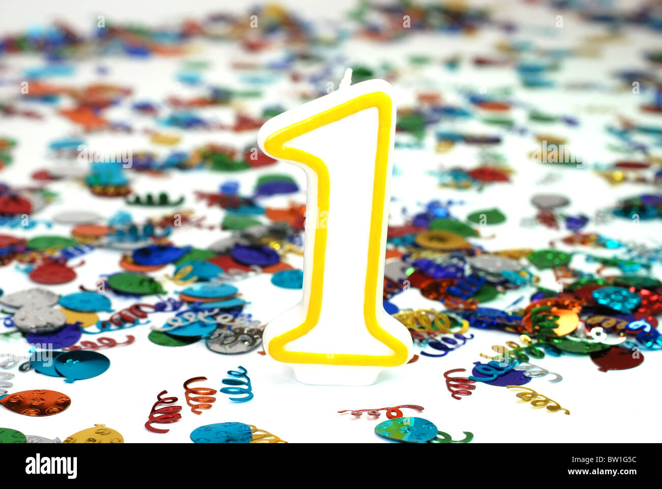 Number 1 celebration candle with confetti. Stock Photo