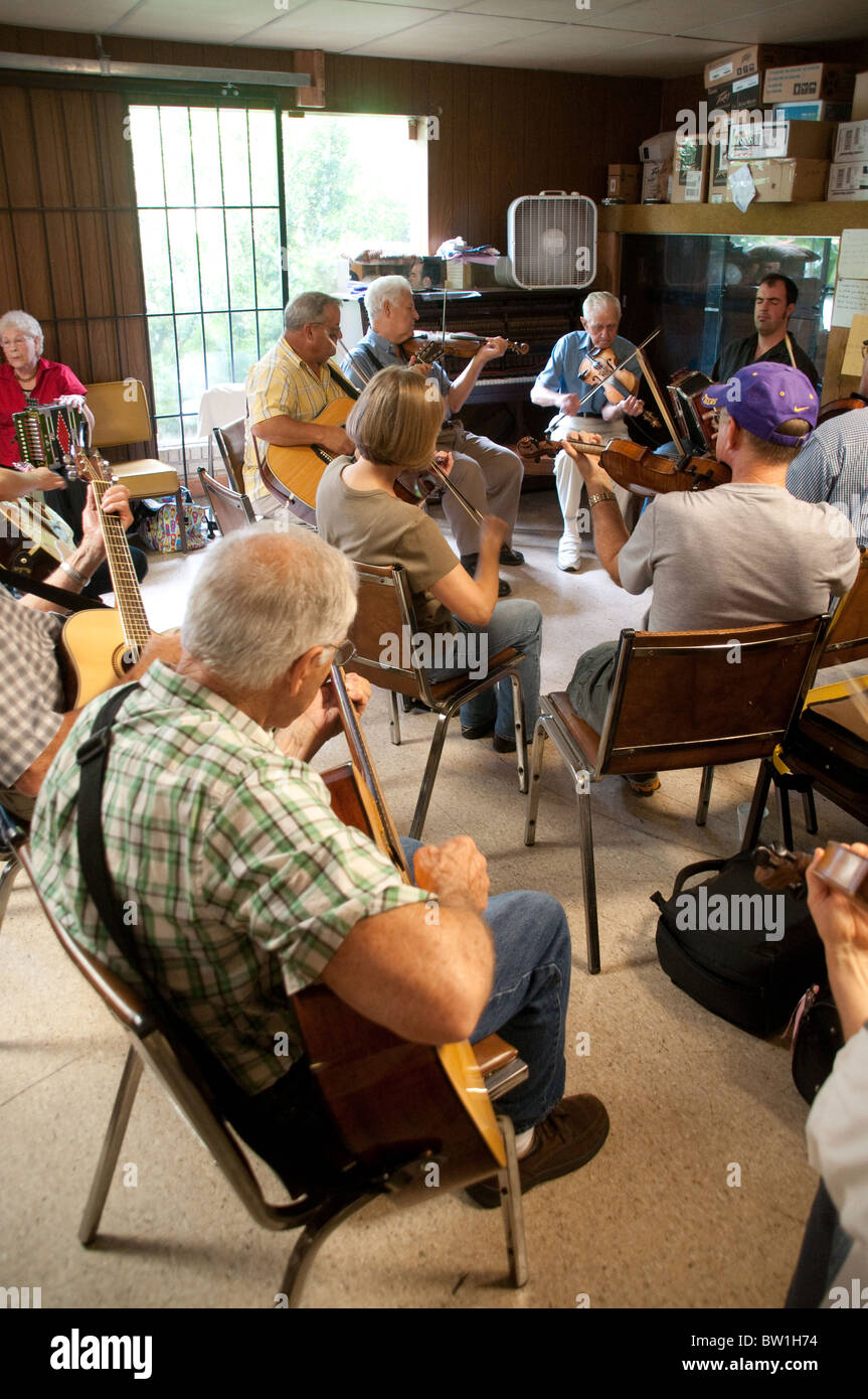 A gathering of Cajun musicians taking part in a weekly acoustic jam session at the Savoy Music Center in the town of Eunice, near Lafayette Louisiana Stock Photo