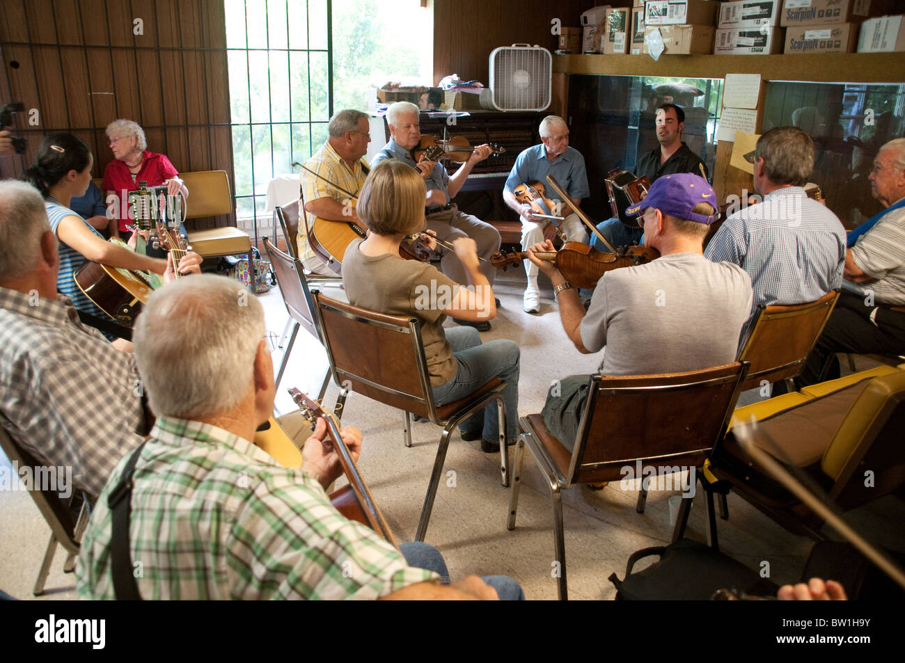 A gathering of Cajun musicians taking part in a weekly acoustic jam session at the Savoy Music Center in the town of Eunice, near Lafayette Louisiana Stock Photo