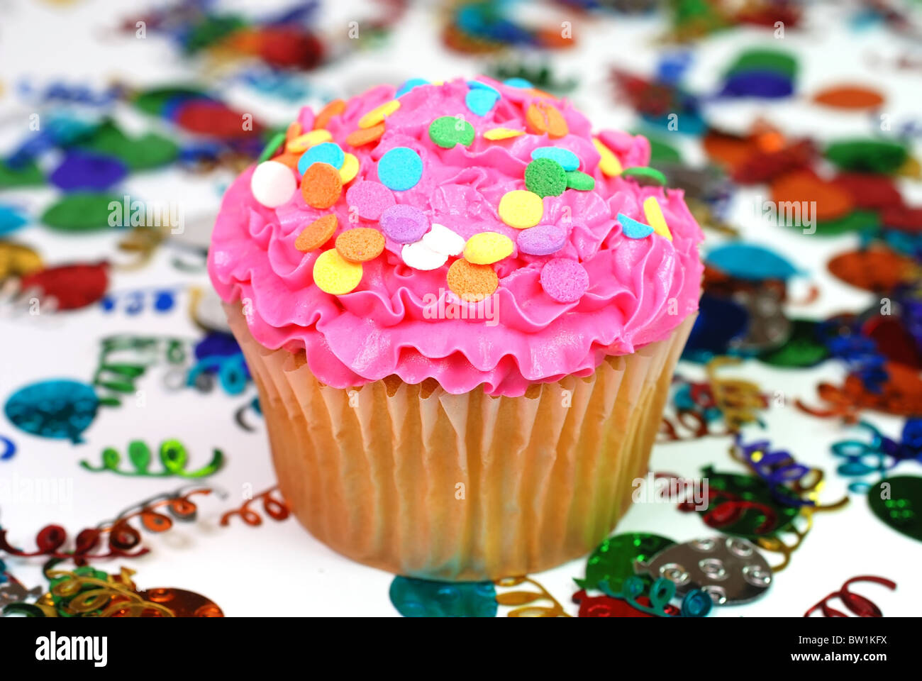 Celebration cupcake with confetti in background Stock Photo Alamy