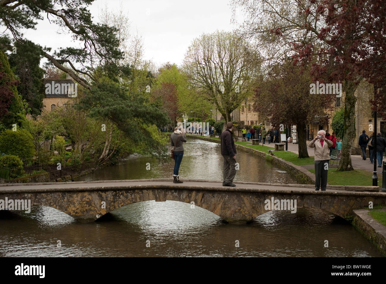 Footbridge over River at Bourton on the Water in the Cotswolds Stock Photo