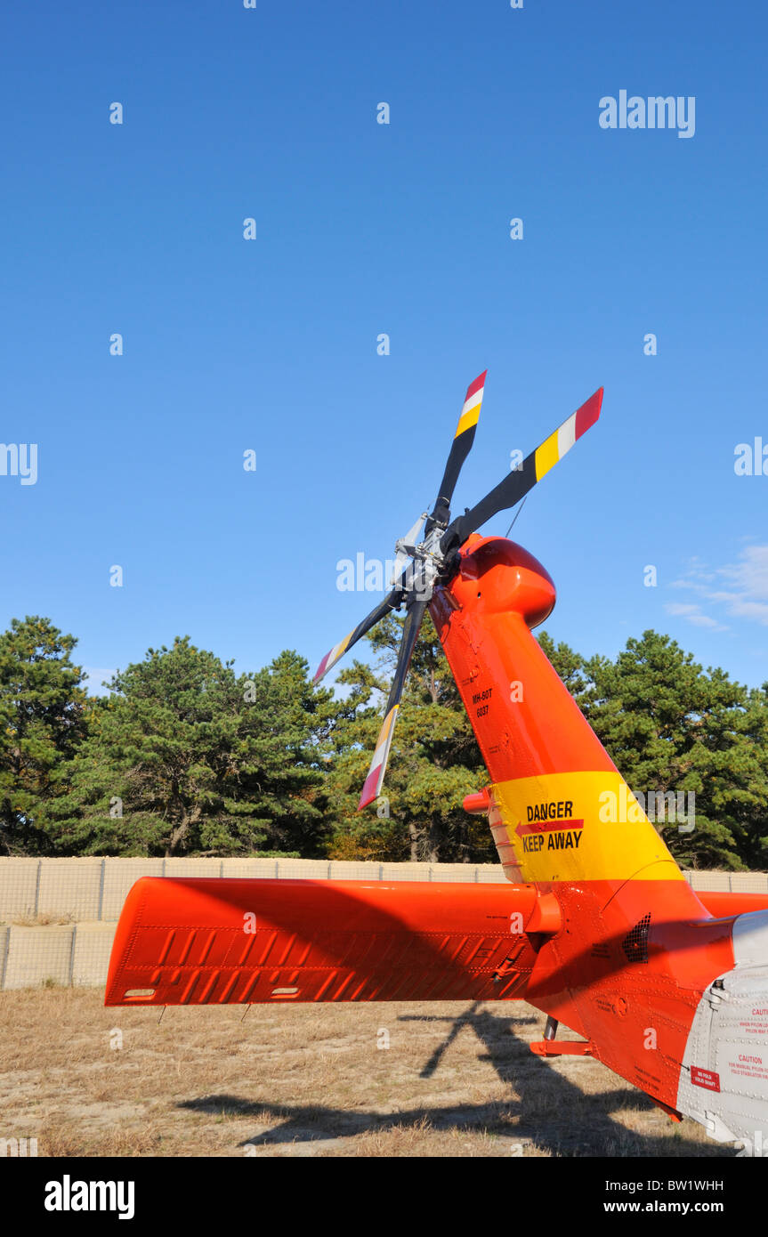 U. S Coast Guard Jayhawk Helicopter tail section parked on ground . Stock Photo